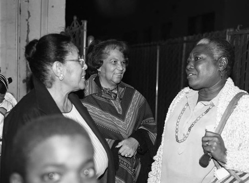 Ester Rolle talking with two women at a night-time event, Los Angeles, 1987