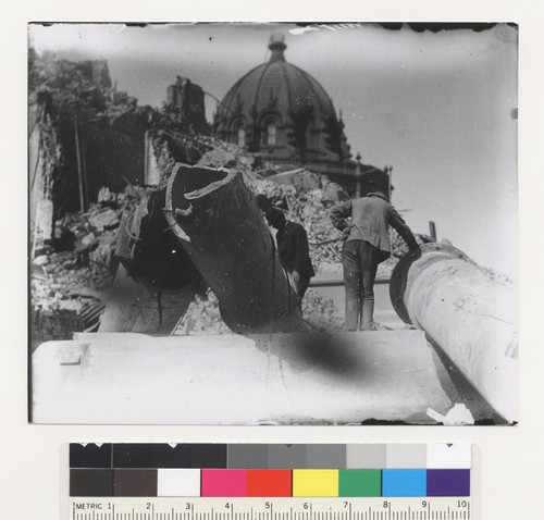[Men among ruins at City Hall. Dome of Hall of Records in distance.]