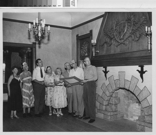 Library staff and visitors admiring the fireplace and mantel