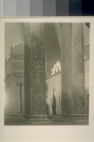 H295. [Colonnade, Tower of Jewels. Palace of Manufactures, behind; "The Nations of the East," atop Arch of the Rising Sun, illuminated in distance.]