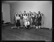 Leo Christiansen kneeling in front of chorus, California Labor School