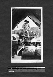 View of boatman steering, from inside boat, Fujian, China, ca.1920-1930