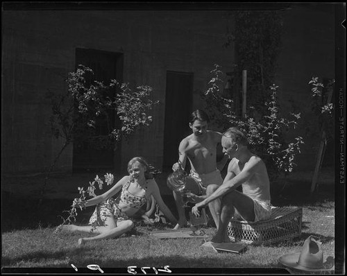 R. Lee Miller, Mrs. Jack Pfister and A. Boyd Mewborn in the sunny patio of Miller's home, Palm Springs