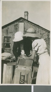 Orville and Augusta Brittell Open Boxes of Supplies, Kalomo, Zambia, ca.1941-1959