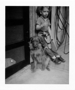 A young cowboy and his dog
