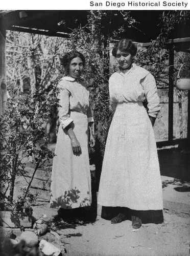 Two women standing outside in a garden