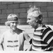Steve Long (left) and his father Bob Long, cyclists, standing and talking