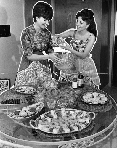 Actress Sandy Descher, right, Woodland Hills and friend, Jean Rambo, prepare fruit punch
