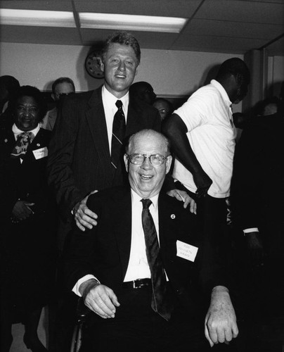 Bill Clinton standing behind Kenneth Hahn in his wheelchair, Los Angeles, 1992