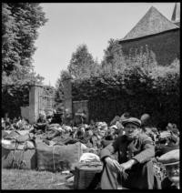 Ardennes evacuation: On road. Before church Mainbressy [Refugees gathered in front of church. Mainbressy, France]