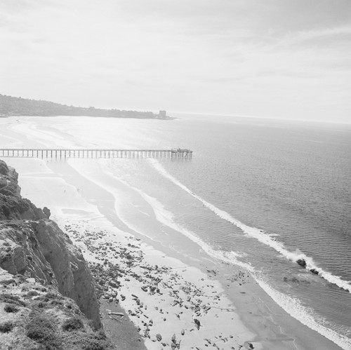 Scripps Institution of Oceanography Pier and the volcanic Dike Rock, at the north end of the beach in front of Scripps. January 30, 1968