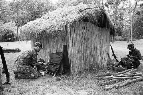 Survival school students near a hut, Liberal, 1982