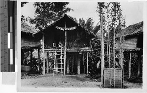 Two people sitting in front of their hut, Solomon Islands, Oceania, 1939