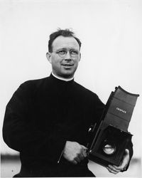 Lorenzo Malone, S.J., with Graflex camera