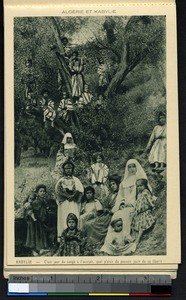 Missionary sisters pose with children near a tree, Kabylie, Algeria, ca.1900-1930