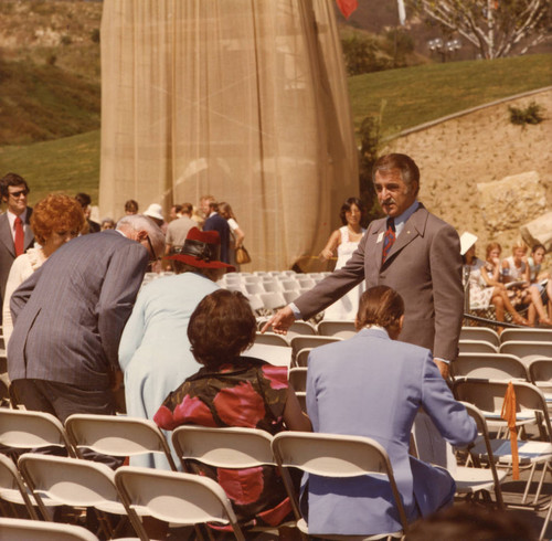Raymond Barnes ushering guests prior to the Firestone Fieldhouse dedication, 1975