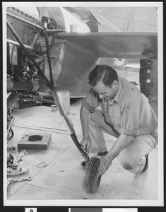 Man assembling part of an aircraft, ca.1940