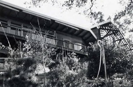 View of a hillside house, text on the back indicates that the image was taken from "Lower 40" (Spencer Chan Family)