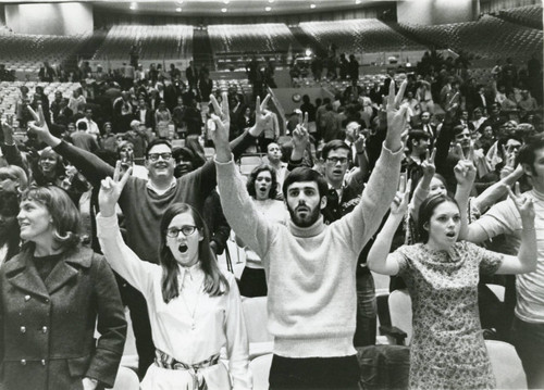 Students reacting at a basketball game, 1970