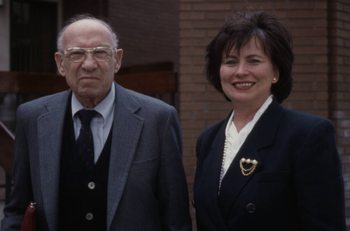 Peter Drucker standing next to an individual