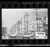 Traffic and billboards along commercial strip of Harbor Blvd. in Anaheim, Calif., 1966