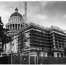 View of the California State Capitol building undergoing restoration. This view is showing the L Street side completely stripped of plaster (on the right) and the 10th Street side partially stripped