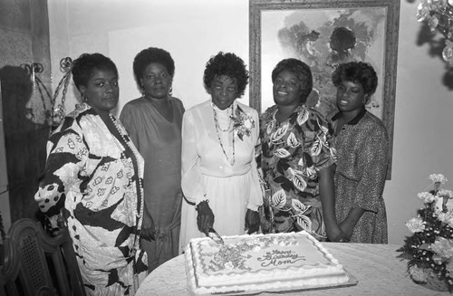 Erma Caldwell posing with others and her birthday cake, Los Angeles, 1991