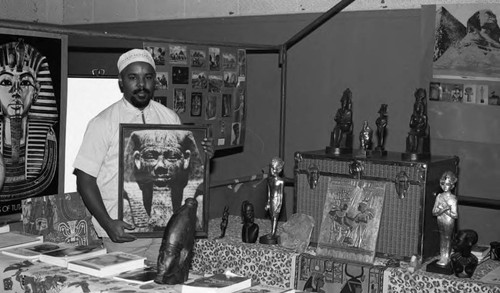 Mahtu Ater displaying items in his booth during the African Festival, Los Angeles, 1986