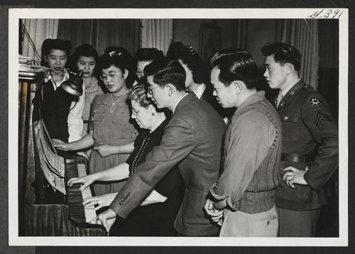 Community singing is still a popular pastime as evidenced by the group shown here. The Caucasian seated at the piano is the ... secretary of the Young Kansas Citians' Club. Kansas City, Missouri