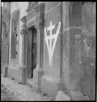 [Micellaneous Village: possibly Ammerschwihr. Symbol of V and cross painted on wall]