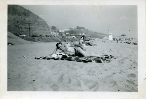 Man reclined on the beach near Santa Monica Canyon, 1949