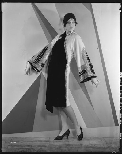 Peggy Hamilton modeling an Adrian coat in black chiffon velvet and cream broadcloth, 1929