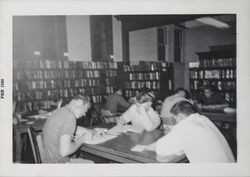 Patrons at work tables in the library on Exchange Avenue