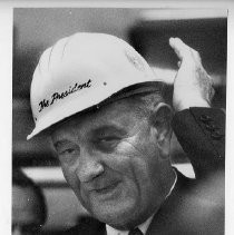 President Lyndon B. Johnson, on a campaign visit to Sacramento, at Aerojet, wearing a hard hat labeled "The President"