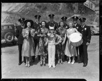 Los Angeles Police Department annual parade color guard members and young drum major pose with officers, July 9, 1937