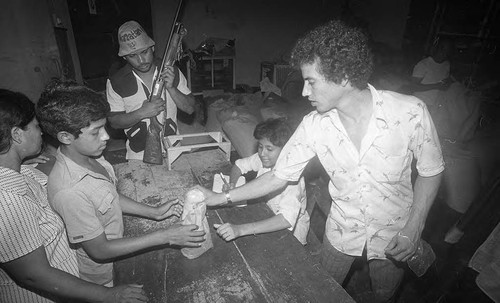 A boy receives food rations, Nicaragua, 1979