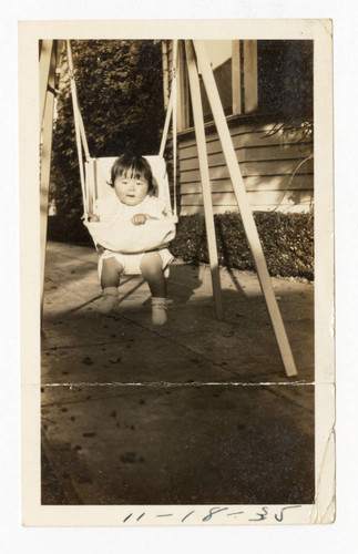 Baby sitting in a swing