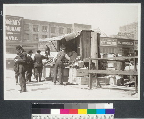 One year after. Close view of fruit stand at the foot of Stockton St