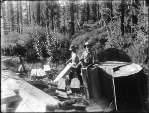 Two men splitting out shakes from cedar logs to be used as shingles, ca.1900