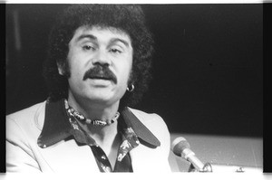 Roberto Vargas speaking at a lecturn, Los Angeles, 1973