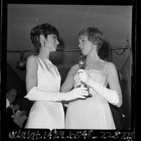 Actress Audrey Hepburn handing Julie Andrews her best actress Oscar for film "Mary Poppins," 1965