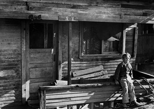 Child in front of shack