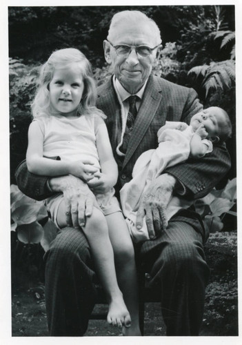 George Pepperdine holding his great-grandchildren