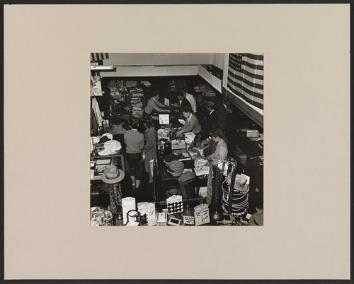 Number 65 - Group 5. April 4, 1942. Post & Buchanan Streets, San Francisco, California. Interior of Japanese dry-goods store during evacuation sale. japanese are buying merchandise preparatory to life in camps