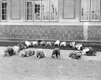 Children kneeling on the ground at San Jose State