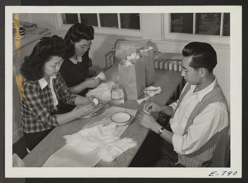 Hospital assistants preparing bandages and gauze sponges for operating room use. All functions of the hospital are performed by center residents (former west coast persons of Japanese ancestry), except the chief doctor and the superintending nurses. Photographer: Parker, Tom Denson, Arkansas