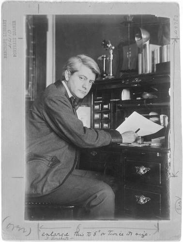 [Frank Norris seated at desk.]