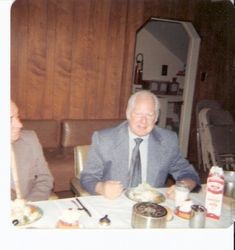 Dr. Horace Sharrocks at dinner table, about 1970