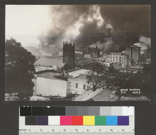 [Cityscape during fire. From Nob Hill looking east toward wholesale district. St. Mary's Church, center.]