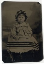 Portrait of infant in dress and bonnet